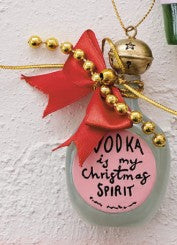 A Christmas ornament shaped like a frosted glass bottle with a pink label reading 'VODKA is my Christmas SPIRIT', decorated with a red ribbon, gold beads, and a small gold bell.