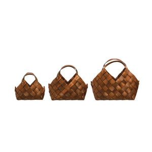 Set of three hand woven seagrass baskets in brown against a white background. Small, medium, and large in size. 