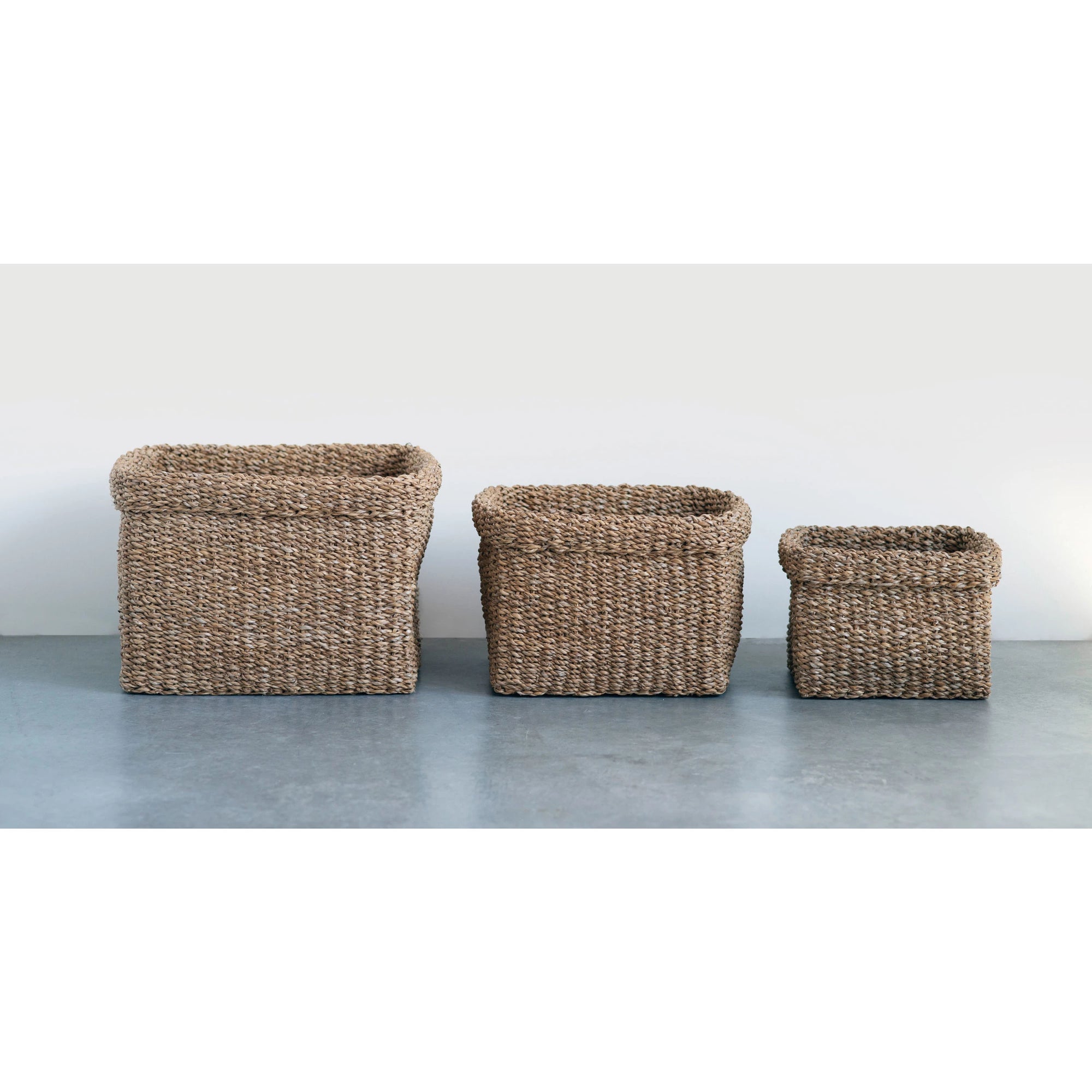 Hand woven natural seagrass baskets in a coordinating series of small, medium, and large. Natural baskets. Organic home decor. Coastal decor. Rustic decor.