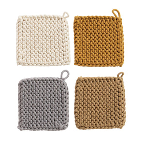 four different colored crocheted potholders spread out