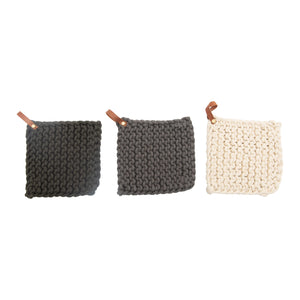 dark gray, gray, and cream colored pot holders with leather loop. 